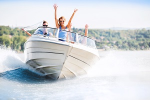 cheerful group of people on a speed boat